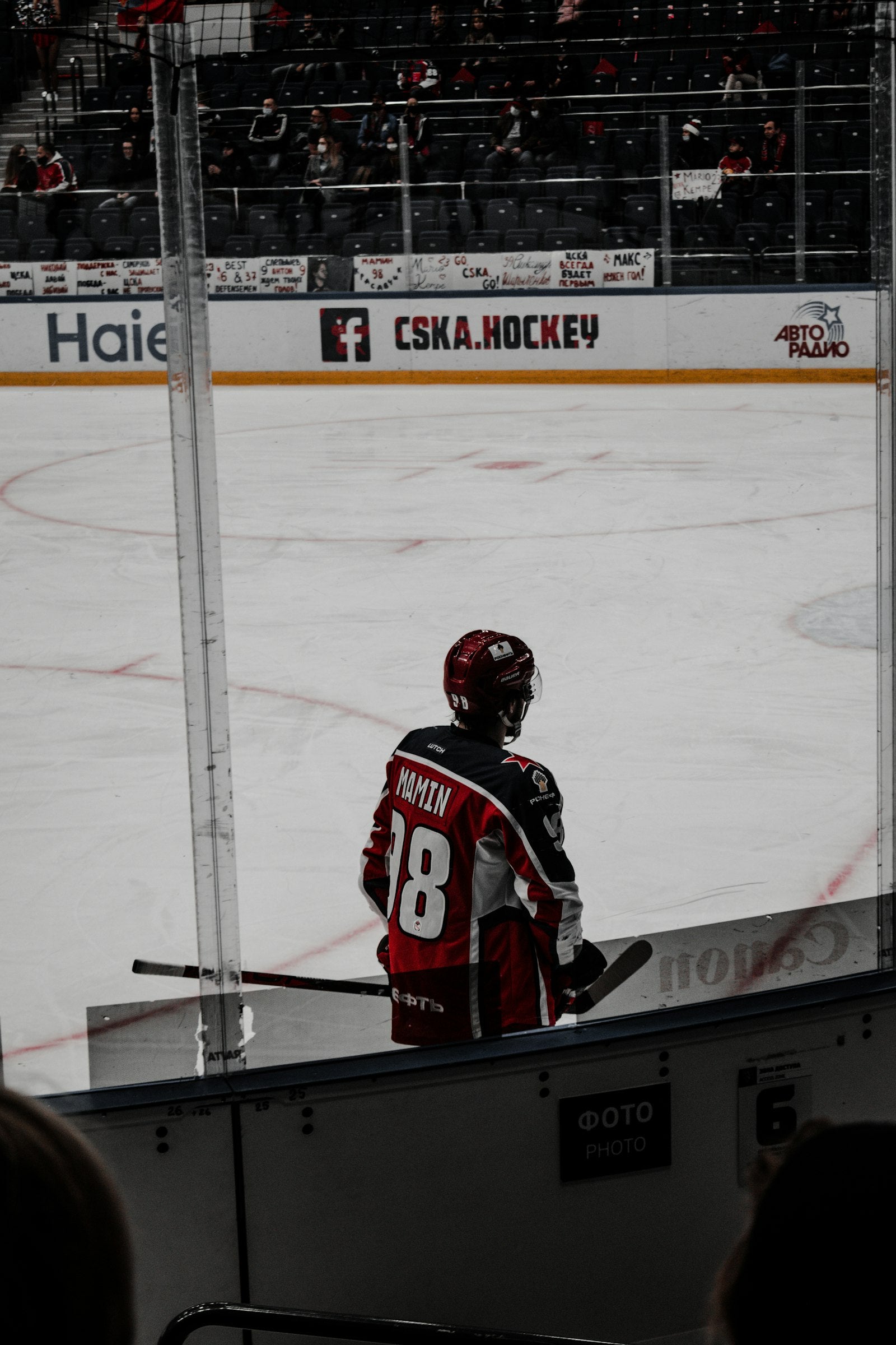 Ice hockey player in a helmet and visor on the rink