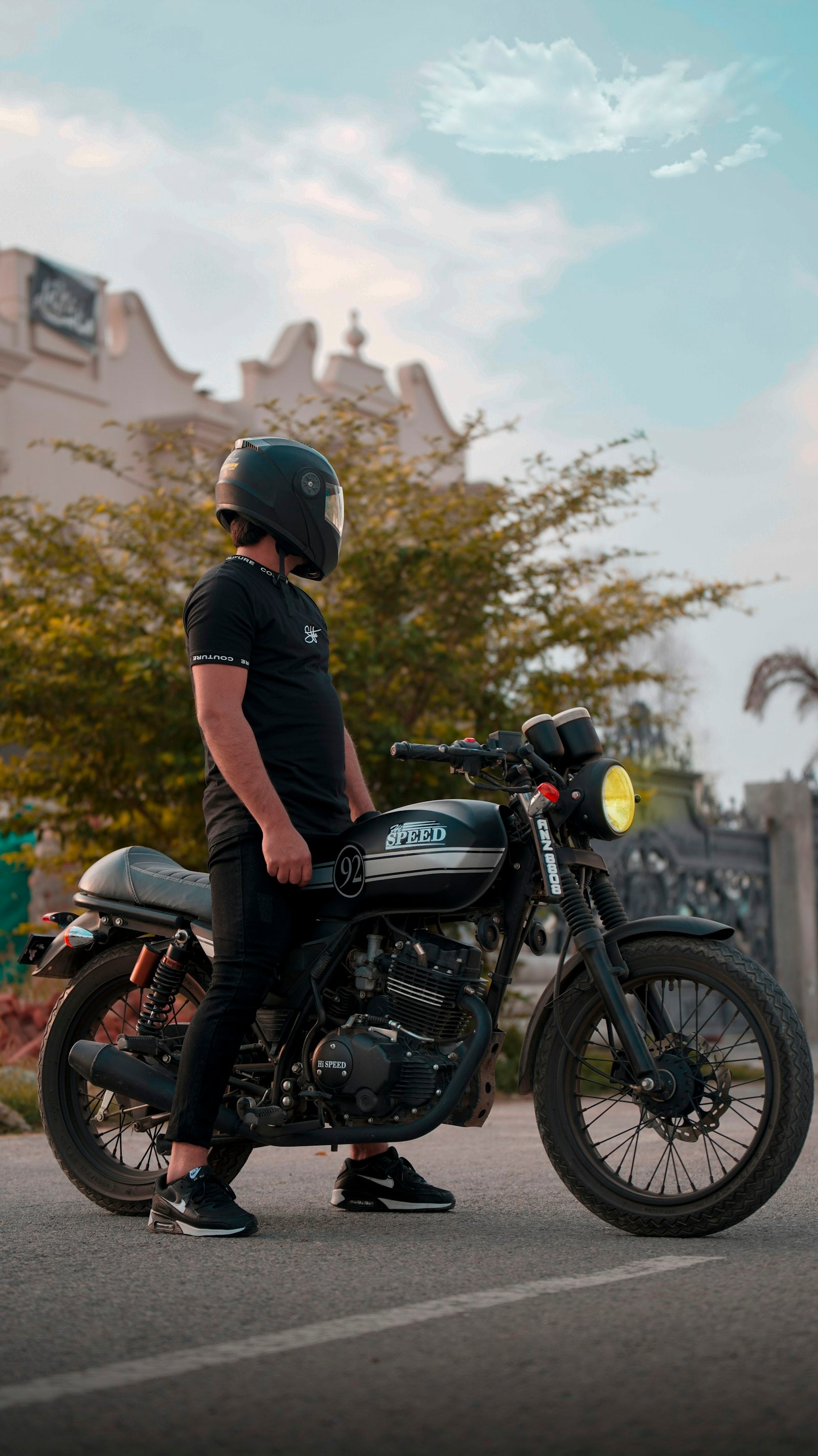 Motorcyclist wearing helmet on a road, clear visor on a touring motorcycle